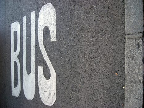 The bus line sign over asfalt of a city street. Copy space avaialble.