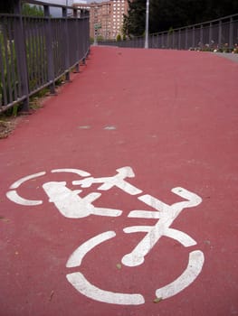 Cyclist line sign over a pedestrian bridge over M-30 highway in Madrid.