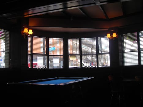 A pool table inside a tavern in London.