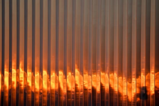 Flaming sunset against the side of a building