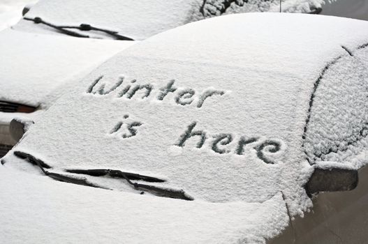 Cars covered by snow during winter storm.