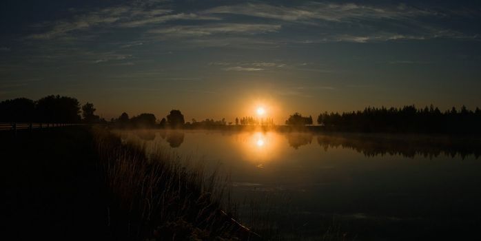 Colorful sunrise on the small lake in Lithuania