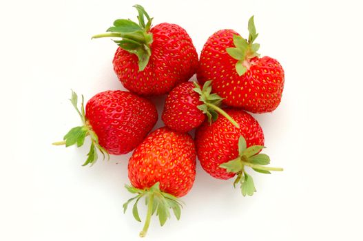 set of fresh strawberries on white painted board