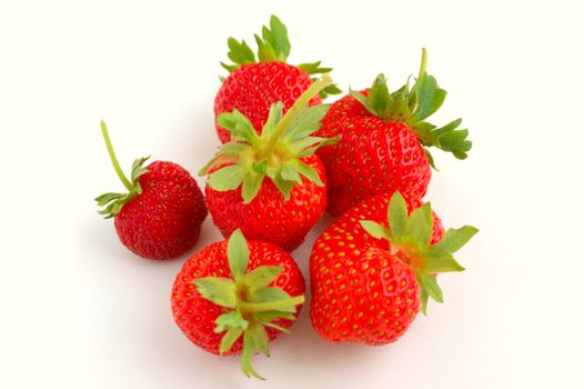 set of fresh strawberries on white painted board