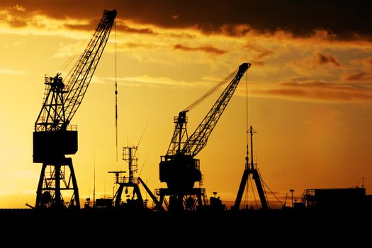 Industrial dock at early dawn - Silhouette of cranes and ships