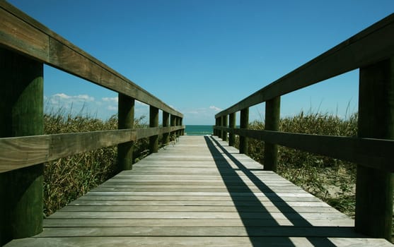 Wooden pathway leading down to a beautiful beach