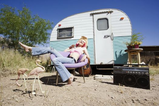 Pretty Woman in a Cowboy Hat in Front of a Travel Trailer