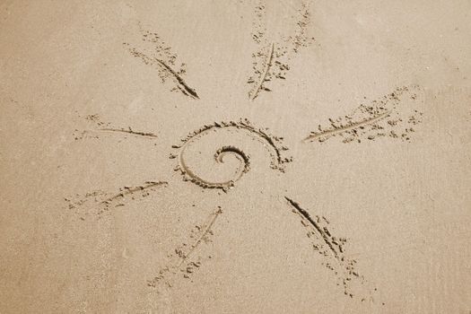 a sun drawn in the sand