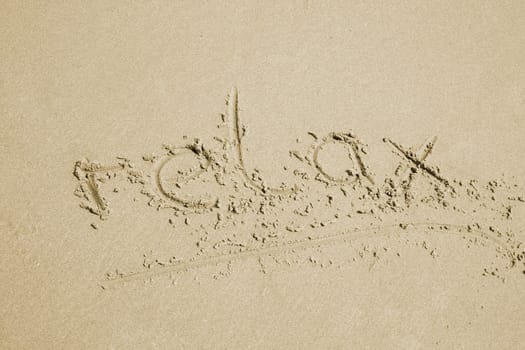 the word relax written in sand