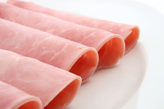 rolled ham on a white plate