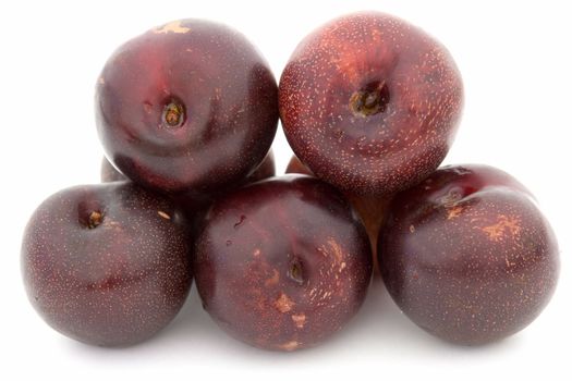 Some big plums on a white background