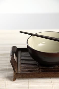 Asian bowl and chopsticks on the serving tray