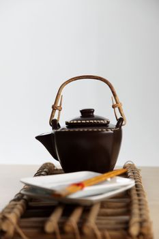 shot of the tea pot and the plate with chopsticks