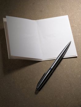 pen resting on a blank card