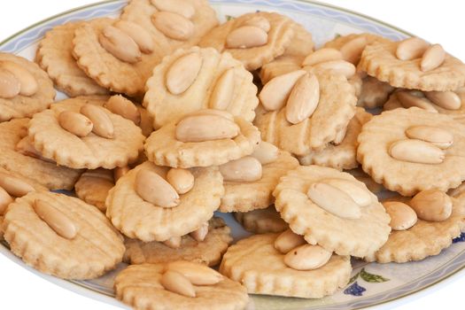a plate with homemade almond pastries isolated on white background