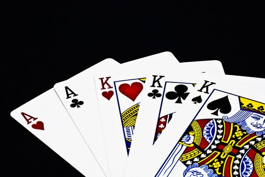 A full house poker hand with black background