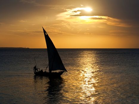 A dhow sailing boat in the sunset in Zanzibar