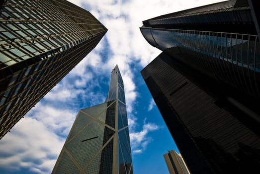 Skyscrapers in Hong kong from below with clouds above