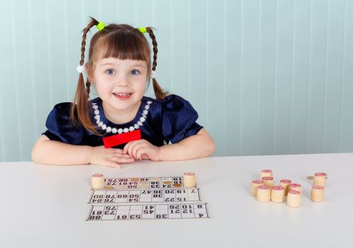 A child sitting at a table and played with bingo