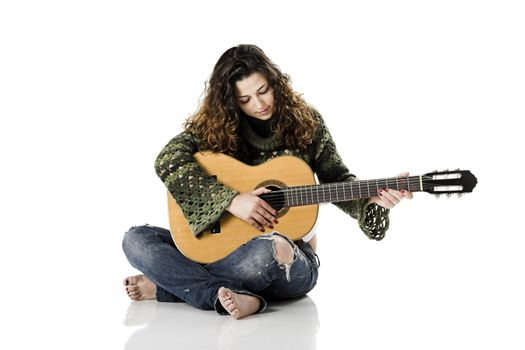 Beautiful woman isolated on white playing music with a guitar