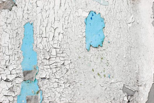 Blue and white peeling paint on the wall grunge background