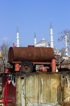 Old rusted water tanker and Blue mosque in background. Istanbul