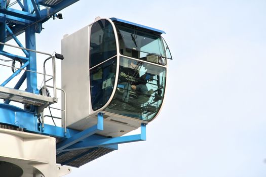 Cockpit of a modern crane with operator at the controls