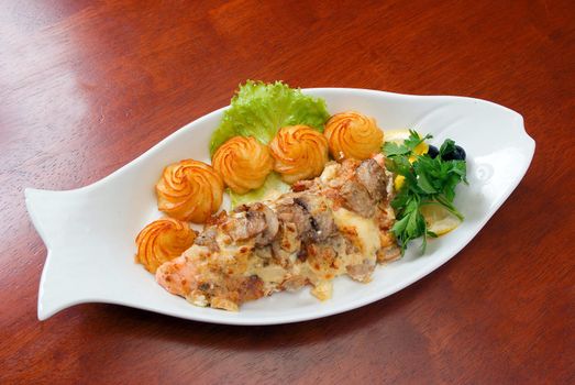 Italian kitchen.Veal with sauce and a potato
