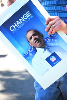 Supporters carring a Barack Obama sign.