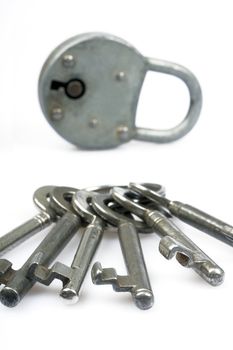 Old fashioned padlock and keys - selective focus on front of keys - shot in studio