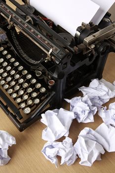 Retro typewriter with paper scattered all around - conceptual image for creative block