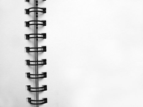 White notebook with black spirals background