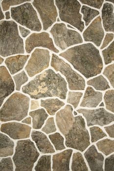 Old fashioned stone wall pattern with different sizes of stone - lit with studio strobes