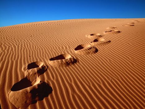 Footprints going over the sand