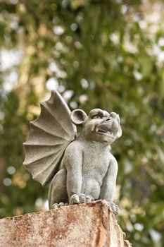 Low angle of stone gargoyle statue outdoors.