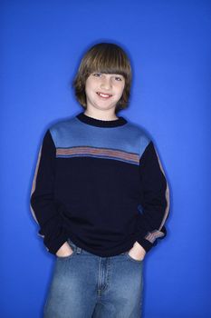 Portrait of Caucasian boy with hands in pockets.