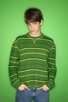 Portrait of Caucasian teen boy with hands in pockets.