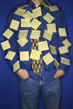 Portrait of Caucasian teen boy covered with sticky notes.