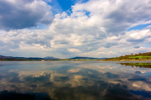 Beautiful sky reflected on calm river waters