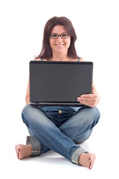 Beautiful brunette woman with brown hair and glasses smiling and sitting while using a laptop computer. Isolated on white background.