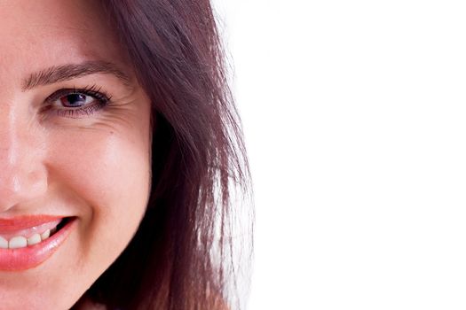 Close-up of a beautiful brunette woman with brown hair smiling.