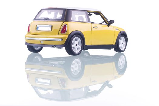 Yellow car with reflection. Studio shot.