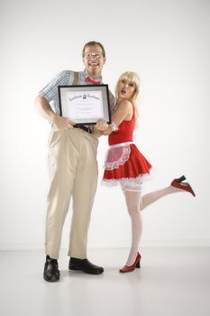 Young Caucasian man holding certificate with young woman.