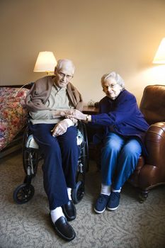 Elderly Caucasian couple in bedroom at retirement community center.