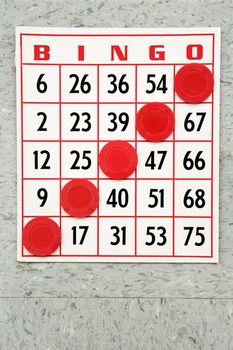 Red bingo card with winning chips.