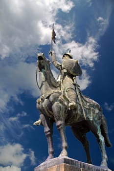 horse knight statue in blue sky with clouds