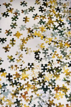 Still life of puzzle pieces on table.