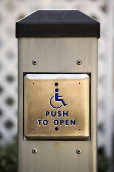 Metal door entrance button for physically challenged or handicapped people.