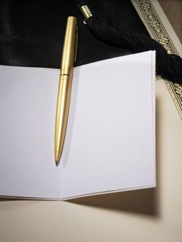 gold color pen on the blank greeting card