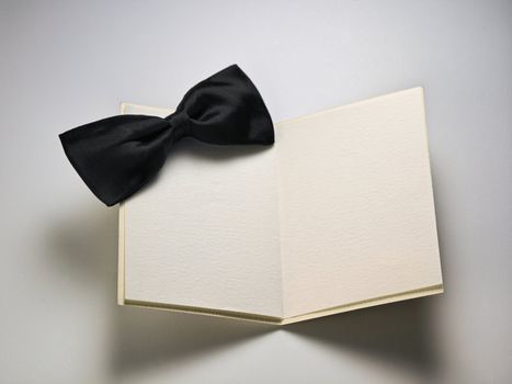 bow tie  on top of a blank card